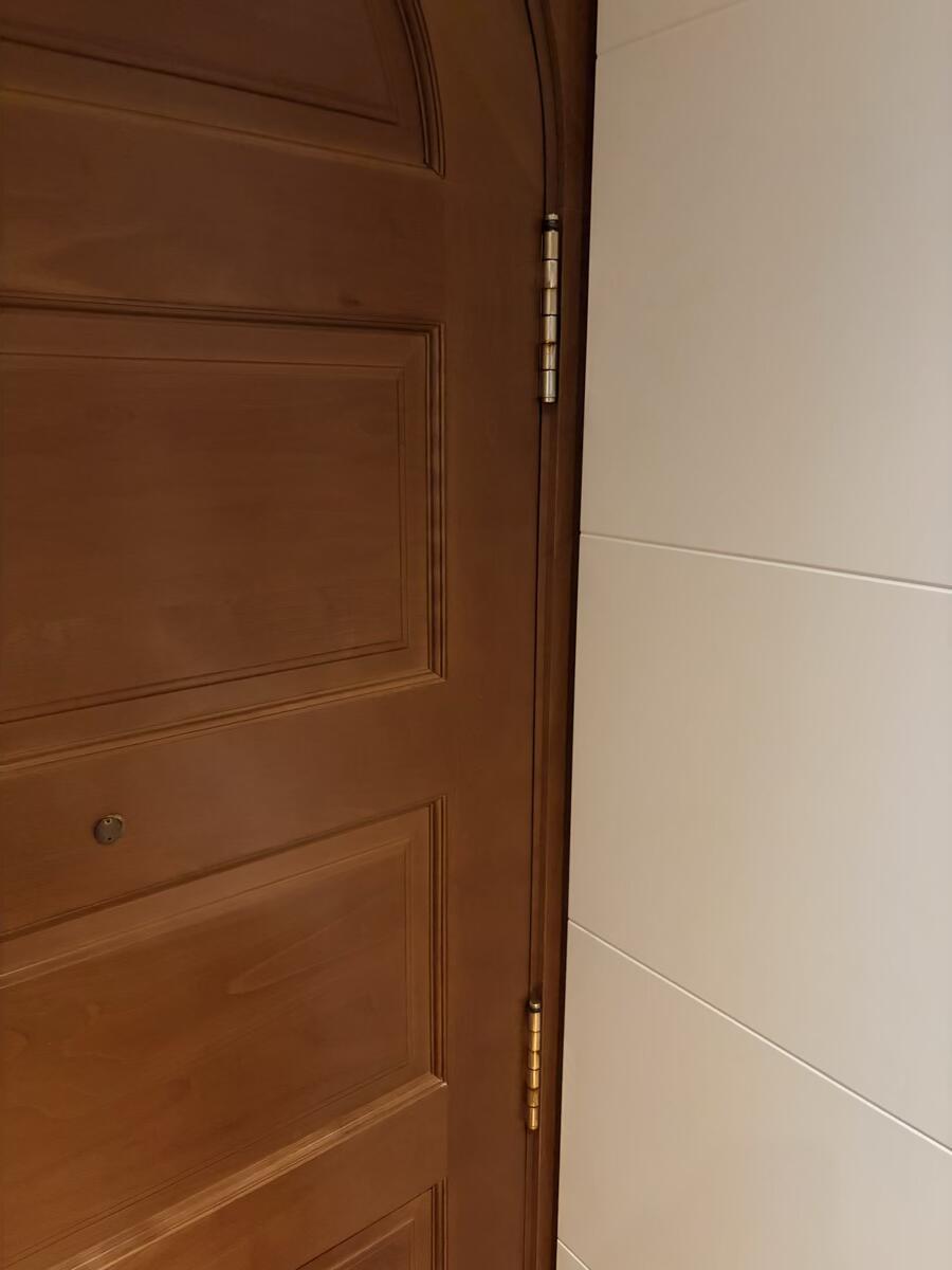 Close-up of an interior door hinge showing the pin and knuckle area