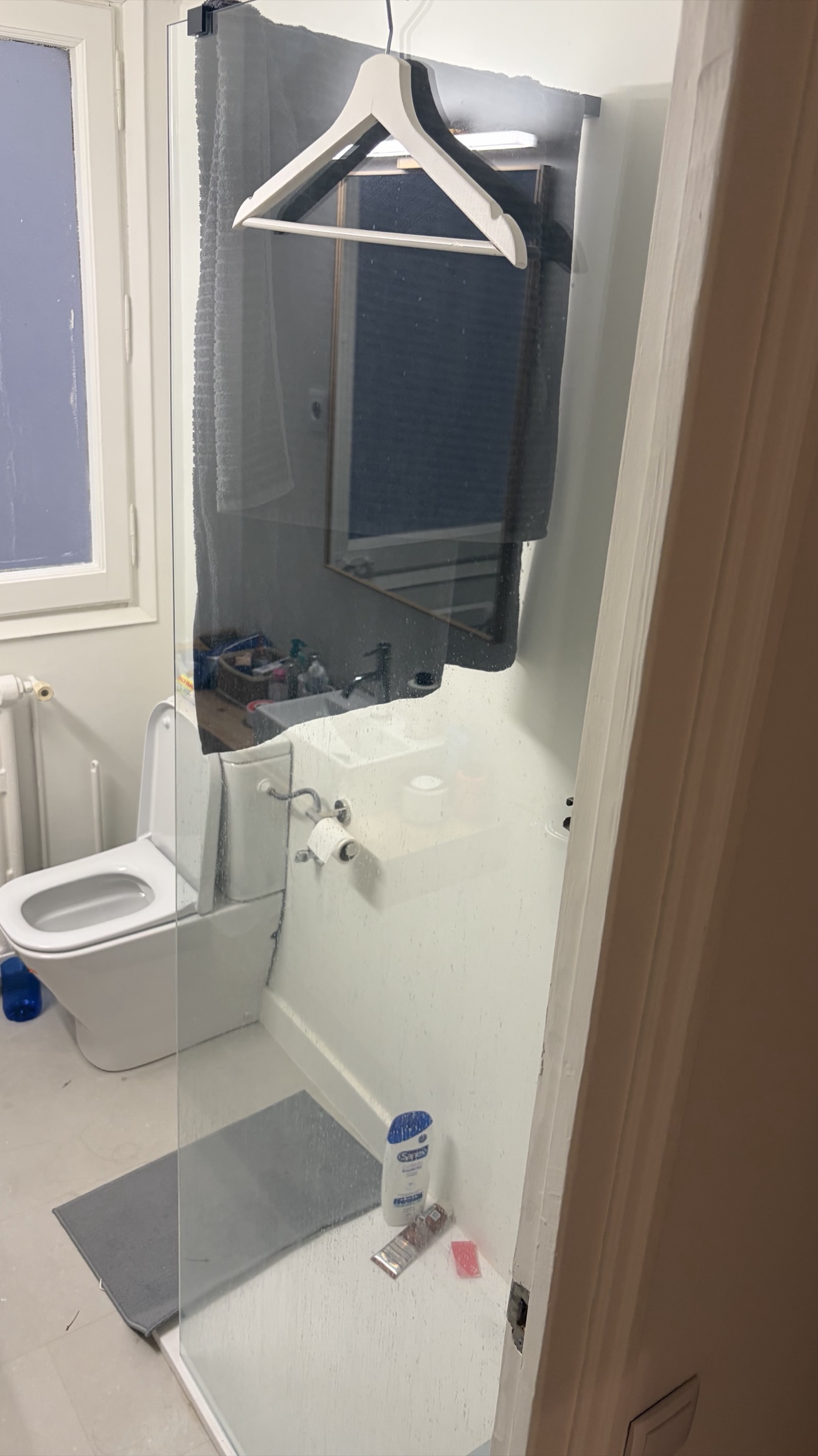 Fixed glass shower screen panel installed on the walk-in shower tray