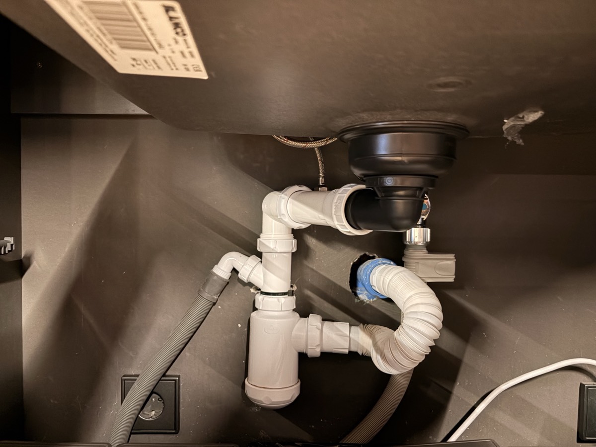 Under-sink plumbing showing P-trap and drain pipes