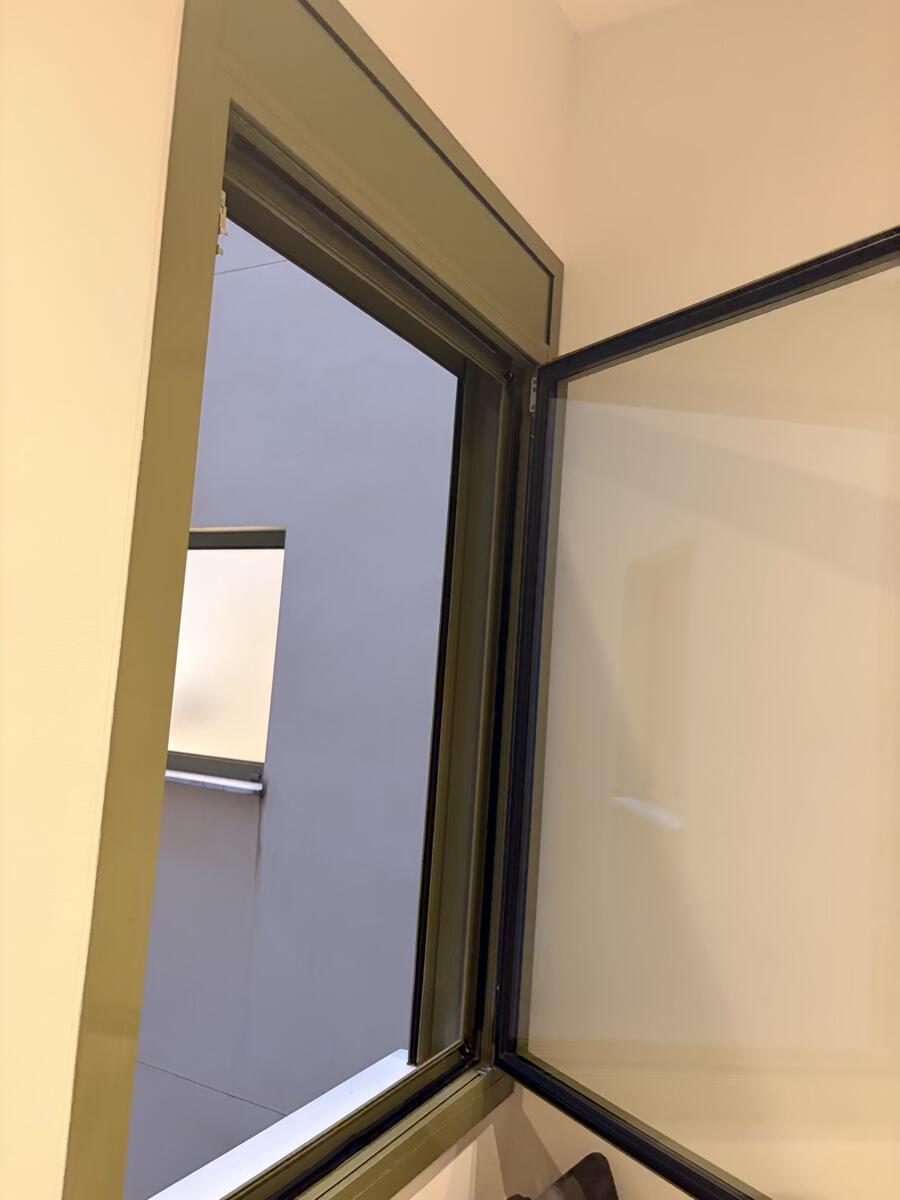 Adhesive foam weatherstripping applied to a window frame to seal drafts